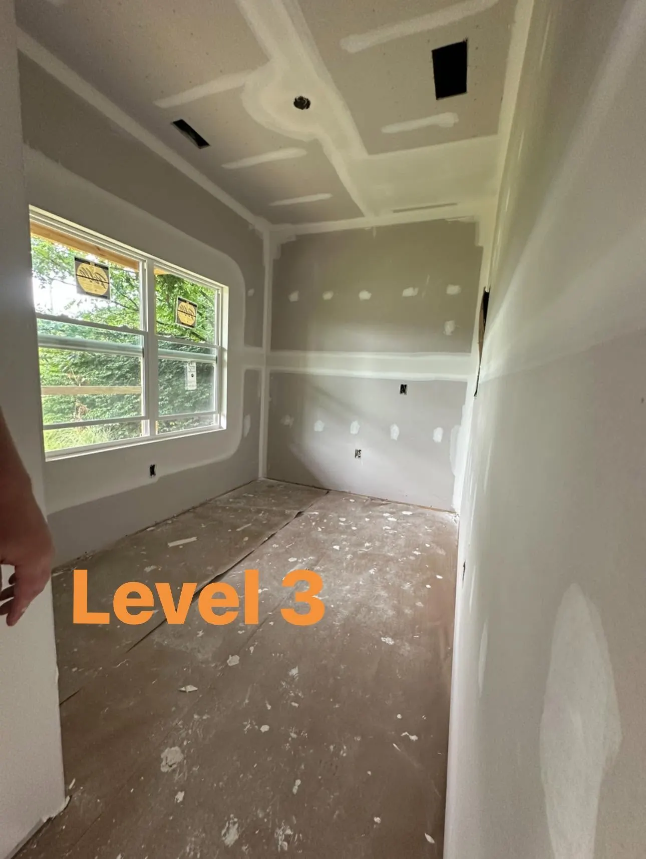 Small room showing Level 3 drywall finishing around walls, windows, and ceiling